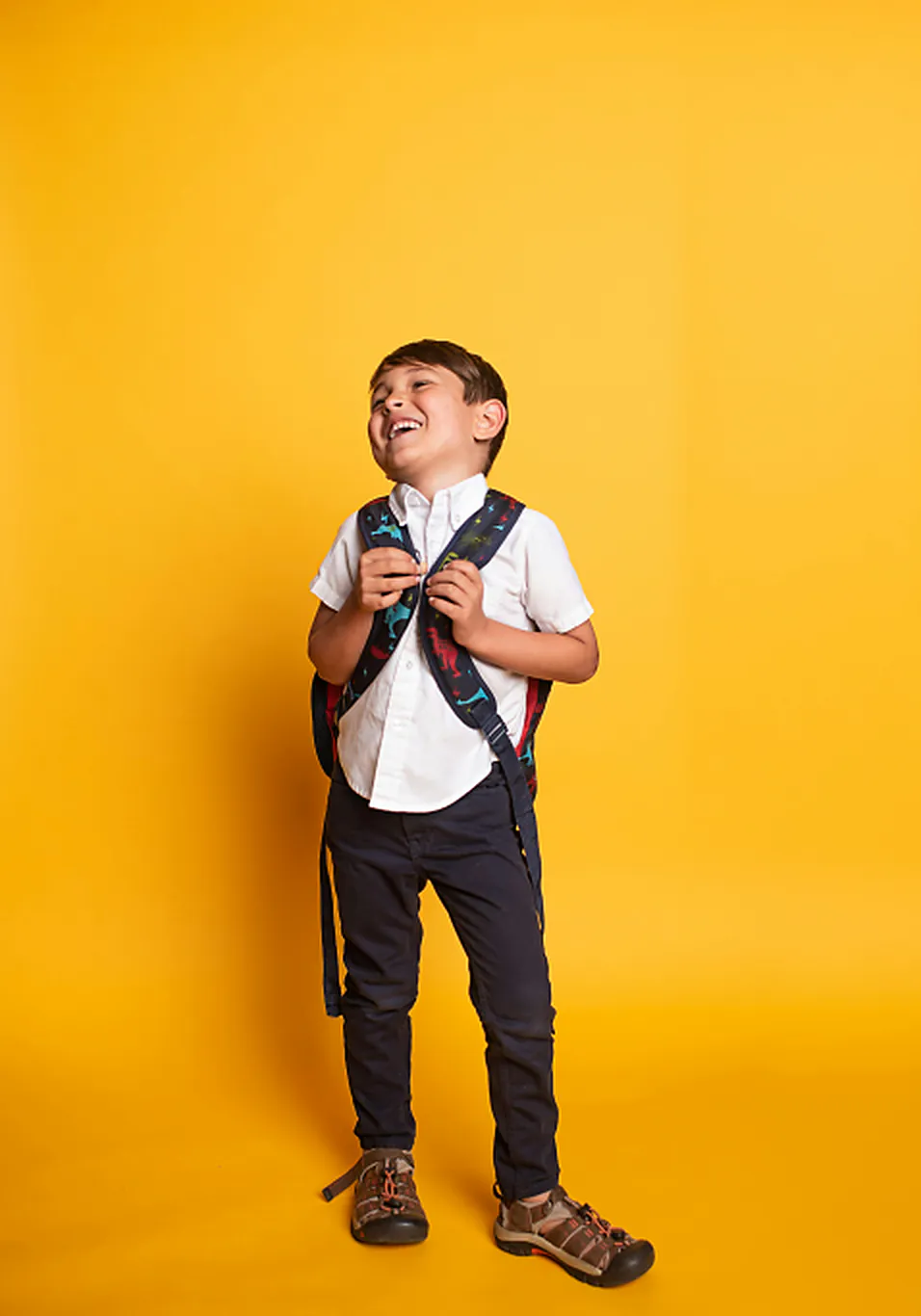 School-age child smiling with a backpack