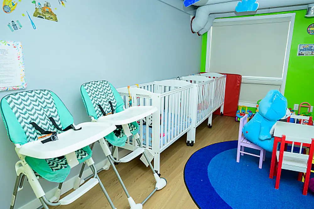 Infant classroom with cots and play area
