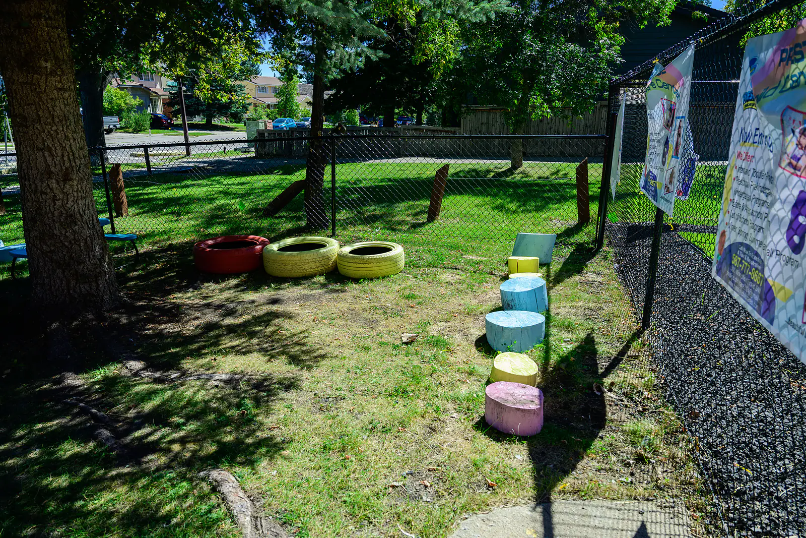 Fenced green outdoor play area at Prestige Childcare Academy